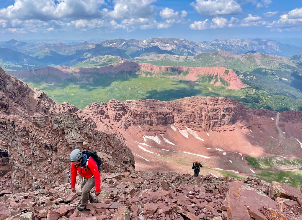 The final push up to North Maroon’s summit, red ridgelines of the Four Loop Pass visible behind us.